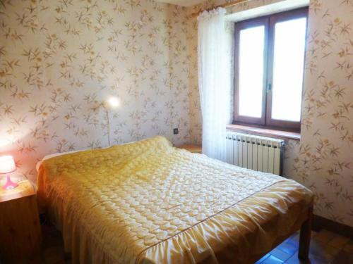 a bedroom with a bed and a window in it at Gîte familial près de La Chaise-Dieu avec jardin, terrasse, jeux pour enfants et équipements bébé - FR-1-582-287 in Saint-Didier-sur-Doulon