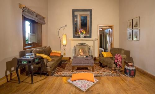 a living room with two couches and a fireplace at Mary Budden Estate in Almora