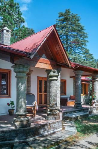 a small house with a red roof at Mary Budden Estate in Almora