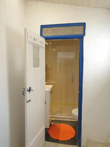 an open door to a bathroom with a shower at Casa Ericeira in Ericeira