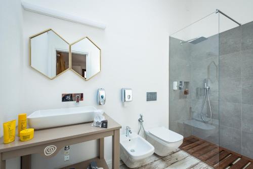 a bathroom with a sink and a toilet and a shower at Tiliguerta Glamping&Camping Village in Costa Rei