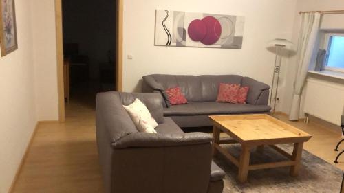 a living room with a couch and a coffee table at Ferienwohnung Villa Tana Miesbach in Miesbach