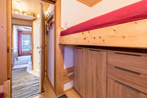 a tiny house with a bed and a hallway at Hochfügenblick-erholung für Zwei in Hochfugen