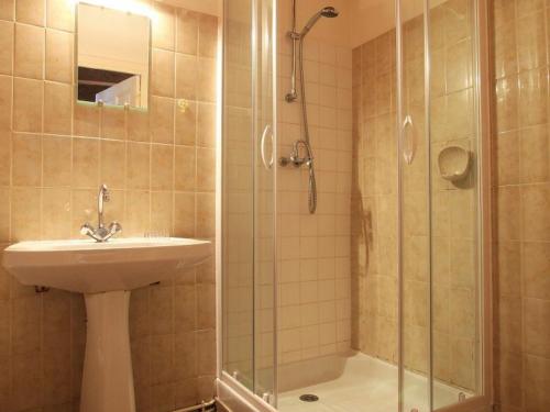 a bathroom with a sink and a shower at Gîte Blesle, 3 pièces, 4 personnes - FR-1-582-14 in Blesle