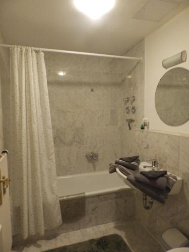 a bathroom with a shower and a tub and a sink at Ferienappartement Königliche Villa Berchtesgaden in Berchtesgaden