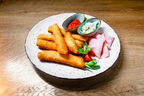 a plate of food with french fries and other foods at Traveling Actor Skadarlija in Belgrade