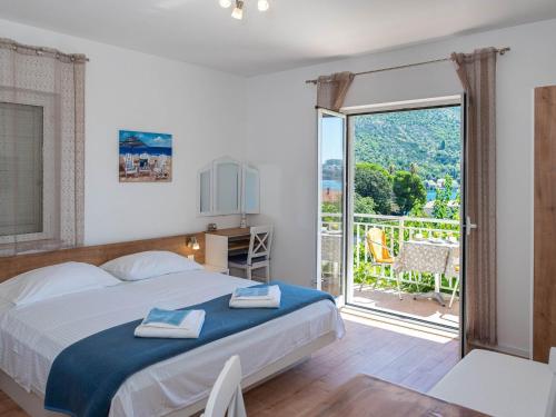 a bedroom with a bed and a large sliding glass door at Apartments Njiric in Zaton