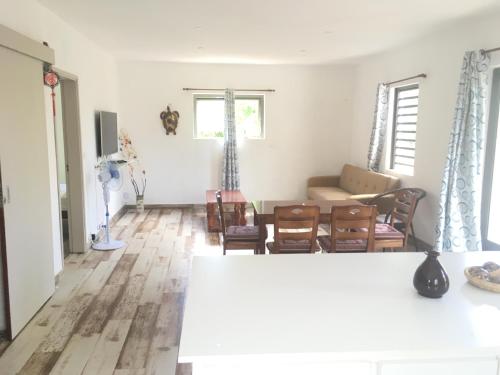 ein Wohnzimmer mit weißen Wänden und Holzböden in der Unterkunft O soleil in Albion