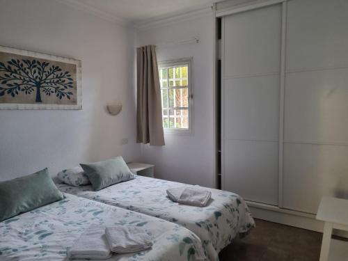 a bedroom with two beds and a window at Maspalomas tisalaya park in Maspalomas