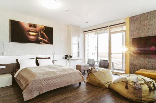 a bedroom with a large bed and a large window at sky FLAT jacuzzi sauna 27 FLOOR in Klaipėda