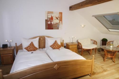 a bedroom with a bed and a table and chairs at Rixbecker Alpen - Hotel Koch in Lippstadt