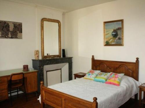 a bedroom with a bed with a fireplace and a mirror at Gîte Toul, 4 pièces, 7 personnes - FR-1-584-74 in Toul