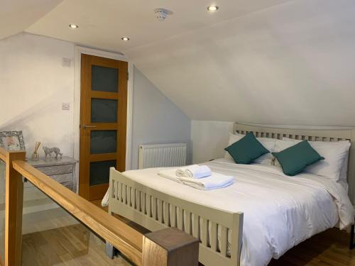 a bedroom with a large white bed with blue pillows at Weslie Guest House in Brighton & Hove