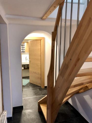 a hallway with a wooden staircase in a house at Hanna`s Home in Innsbruck