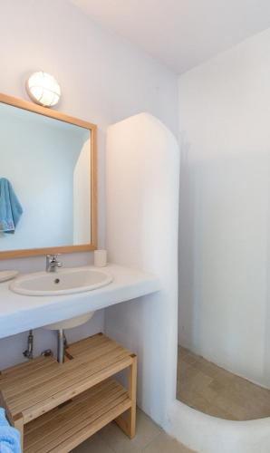 a bathroom with a sink and a mirror at Serifos Stone Villa A in Rámos