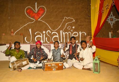a group of men posing for a picture in front of a sign at Garh Meera - A Sensational Boutique Hotel in Jaisalmer
