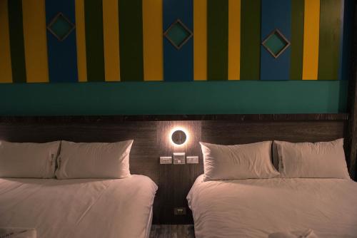 Ένα ή περισσότερα κρεβάτια σε δωμάτιο στο Happy Wing Guesthouse