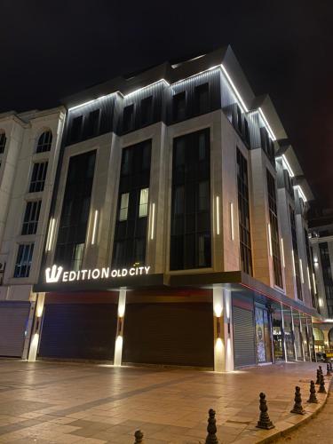 a large building with a sign on it at night at Edition Old City Hotel in Istanbul