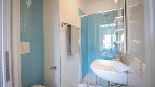 Un baño con lavabo y ducha de cristal. en Dimora Paradiso, Monopoli, Puglia, Sea-View, Stylish, Family Friendly Home, en Monopoli