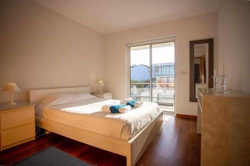 a bedroom with a bed and a large window at Marina de Vila Franca do Campo in Vila Franca do Campo