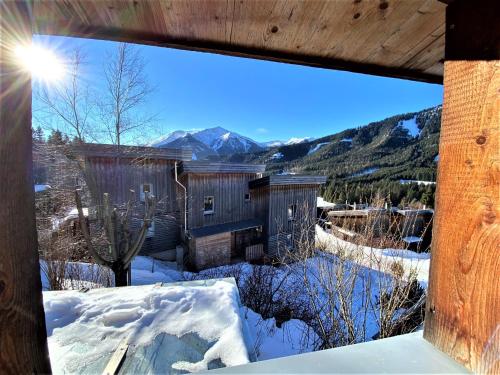 a view from a window of a house in the snow at EXCLUSIVES Chalet an der SKIPISTE +Dampfbad +NETFLIX in Hohentauern