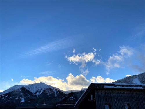 a view of mountains with a blue sky and clouds at EXCLUSIVES Chalet an der SKIPISTE +Dampfbad +NETFLIX in Hohentauern