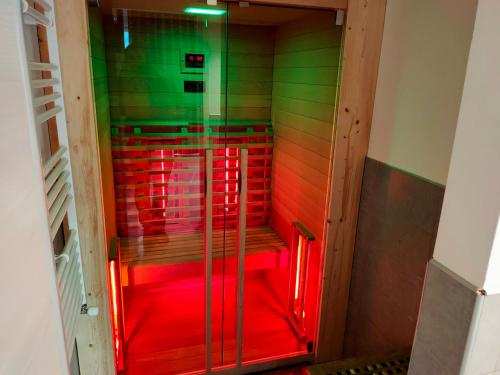 a glass shower with red lights in a room at Residence Cristine in Riva del Garda