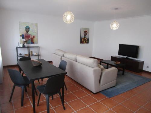 a living room with a couch and a table at The Artist´s Apartment in Espinho