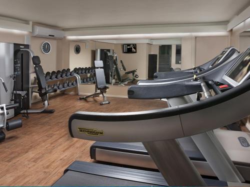 a gym with a bunch of treadmills and machines at Dan Carmel Haifa in Haifa