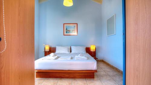 a bedroom with a bed with a blue wall at Barbati Luxury Apartment in Barbati