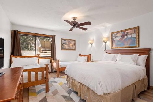 a bedroom with two beds and a ceiling fan at Shadowbrook 205 in Snowmass Village
