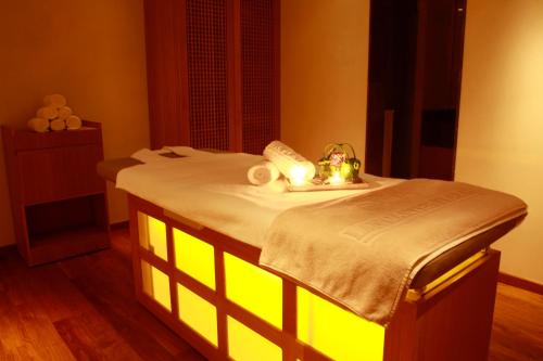 a room with a bed with lights on it at Lancaster Plaza Beirut in Beirut