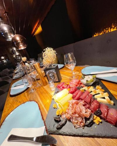 a wooden table with a plate of food on it at DU GLACIER Boutique & Traditions Hotel in Fiesch