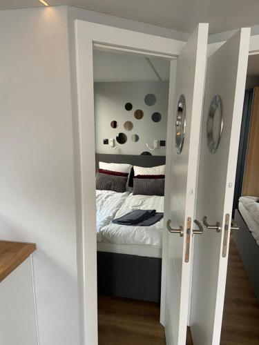 a small bedroom with a bed and a door leading into a room at La Mare Resort in Gothenburg