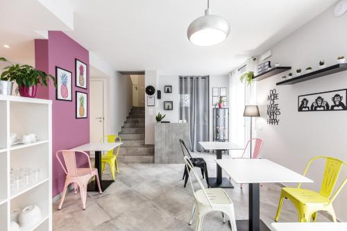 a restaurant with tables and chairs and a staircase at Mincio Relais in Castelnuovo del Garda