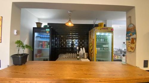 a room with two refrigerators and a counter top at Pousada Encantos do Sul in Pinheira