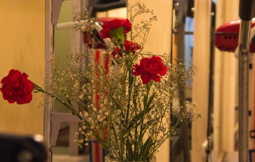 a vase filled with red roses and other flowers at Marhaba Palace Hotel in Aswan