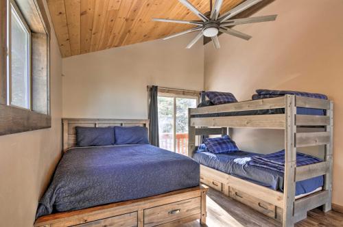 a bedroom with two bunk beds and a ceiling fan at Longview Lodge with Furnished Deck and Fire Pit! in Alton