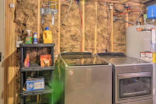 a laundry room with a stove and a refrigerator at Longview Lodge with Furnished Deck and Fire Pit! in Alton