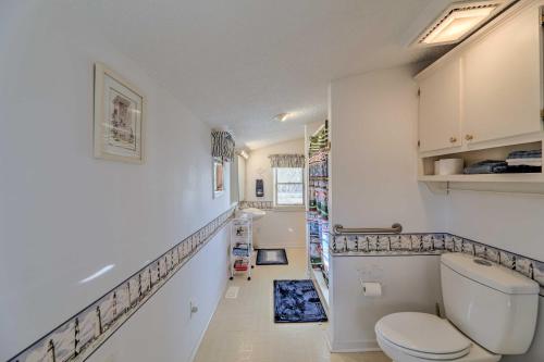 a small bathroom with a toilet and a staircase at Cozy Cottage with Shared Dock on Dawson Creek in Oriental