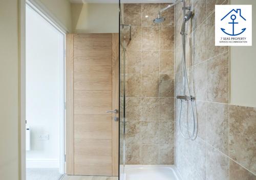 a shower with a glass door in a bathroom at Luxury 2 Bed Apartment by 7 Seas Property Serviced Accommodation Maidenhead with Parking and Wifi in Maidenhead
