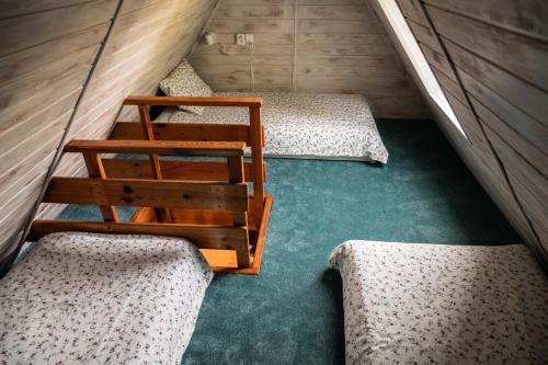 a room with three beds in a small room at Penzion La Baita in Branná