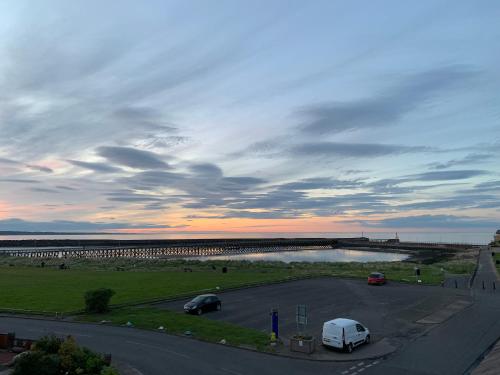 a view of a parking lot with a bridge at The Anchorage - sea views and beach on doorstep in Amble