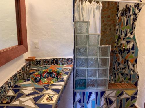 a bathroom with a shower and a tiled floor at Casa Miguel Arcangel in Coatepec