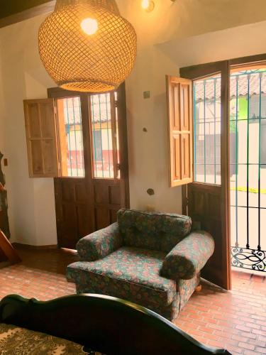 a living room with a couch and a chair at Casa Miguel Arcangel in Coatepec