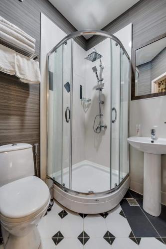 a bathroom with a shower and a toilet and a sink at House 52 Boutique Hotel in Tbilisi City