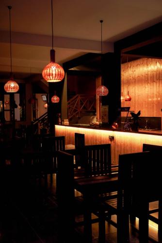 a restaurant with a table and chairs and lights at Adams Peak Inn in Adams Peak