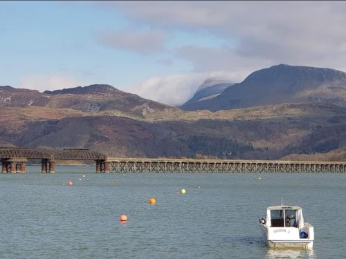 a boat in the water next to a bridge at Barmouth Lyons Sunnysands 346 in Talybont