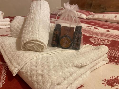 a pile of towels sitting on top of a bed at Rascard Monterosa in Champoluc