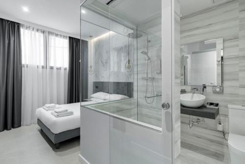 a white bathroom with a shower and a sink at EMBA ROOM in Madrid
